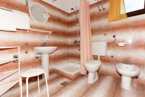 a bathroom with a sink and a toilet and a shower at Apartments Spavalo in Pag +22 photos