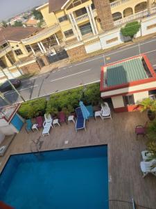 an overhead view of a swimming pool with chairs and avisor at Executive Studio Apartment in East Legon