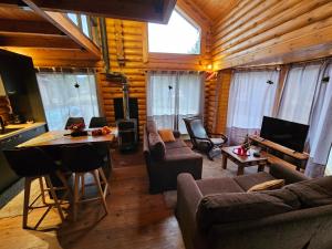a living room with a couch and a table at Orino Livadi Chalet II in Arachova
