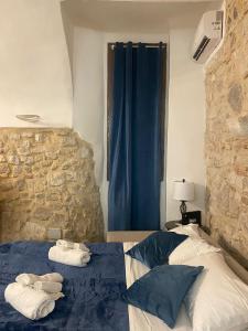 a bedroom with a bed with towels on it at Grotta Abati in Gaeta