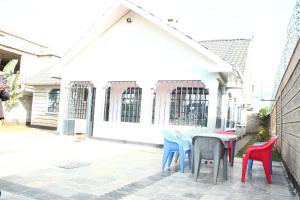 a table and chairs in front of a building at Ms Safari in Thika