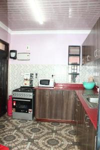 a kitchen with a stove and a counter top at Ms Safari in Thika
