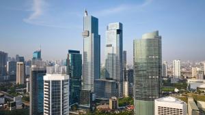 a group of tall buildings in a city at PARKROYAL Serviced Suites Jakarta in Jakarta