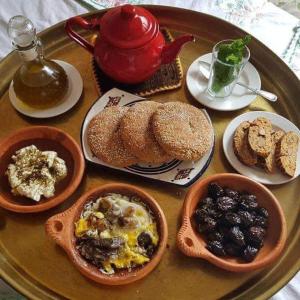 a tray with plates of breakfast food on a table at Dar Nomad Tagounite in Zagora