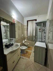 a bathroom with a sink and a toilet and a shower at La Palma apartment in Vigevano