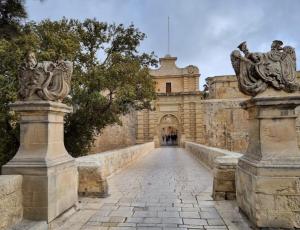 an entrance to a building with a stone walkway at The Misraħ at Rabat in Rabat