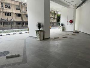 a large room with a tile floor and white walls at The Riveria City Brickfield by GoMain in Kuala Lumpur