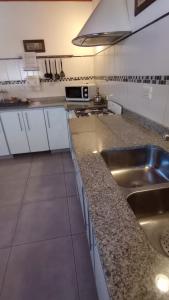 a kitchen with a sink and a counter top at Noreen Departamentos in San Martín de los Andes