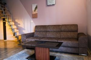 a living room with a couch and a coffee table at Apartments Vukalovic in Medulin