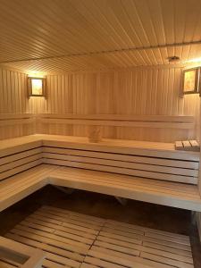 a wooden bench in a sauna with two lights at Sunny Paradise in Tsaghkadzor in Tsaghkadzor