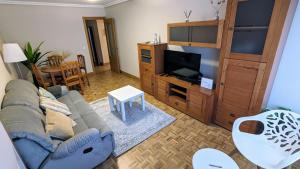 a living room with a couch and a flat screen tv at Zumaia Basque Alai in Zumaia