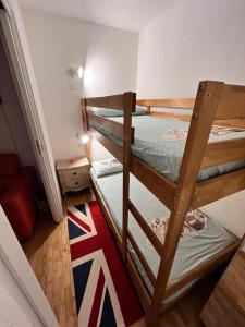 two bunk beds in a room with a flag on the floor at White House in Sauze dʼOulx