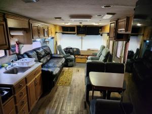 a living room and kitchen of an rv at Dark Ridge HideOut in Elk Park