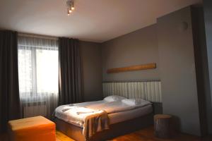 a small bedroom with a bed and a window at N.Joy Holiday Apartment 417 by Sunny Hills in Pamporovo +16 photos