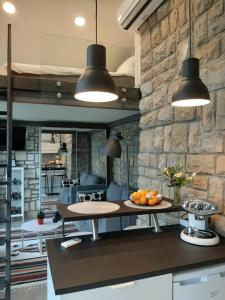 a kitchen with two pendant lights and a table at Studio Solare in Portorož