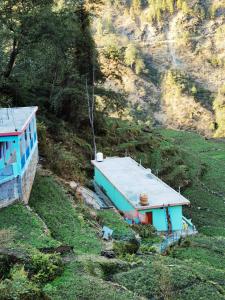 a house on the side of a hill at Holiday Home Chopta Tungnath in Ukhimath