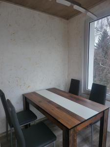 a table and chairs in a room with a window at Angel in Altenburg