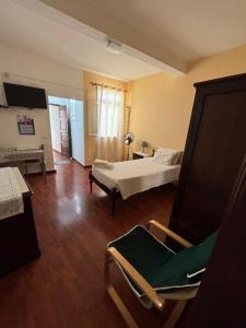 a room with a bed and a chair in it at Cc39-Q6 in Funchal