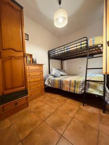 a bedroom with two bunk beds and a dresser at Águila Real in Arroyo Frio