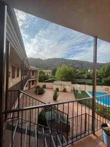 a balcony with a view of a swimming pool at Águila Real in Arroyo Frio +8 photos