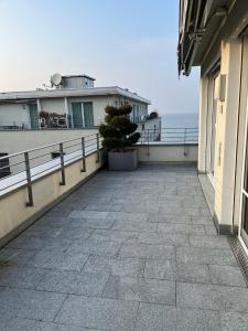 a balcony of a building with a potted tree on it at SEASIDE Appartement in Staad