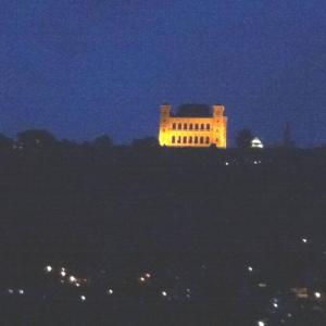 塔那那利佛的住宿－Au coeur de Tana, vue sur le Palais de la Reine, en securité，一座建筑在晚上点亮,灯亮着