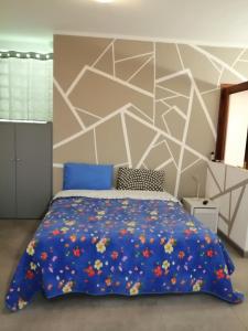a bedroom with a blue bed with flowers on it at MONO PER DUE Cir 0346 in Aosta