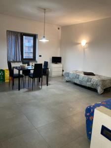 a bedroom with a bed and a table and chairs at MONO PER DUE Cir 0346 in Aosta