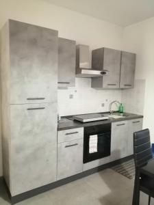 a kitchen with stainless steel cabinets and a stove at MONO PER DUE Cir 0346 in Aosta