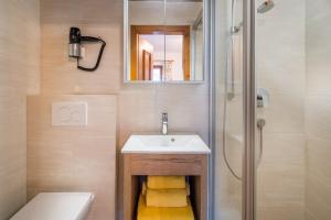 a bathroom with a sink and a shower at Pension Rainhof in Kitzbühel