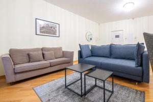 a living room with two couches and a table at Old Town - Demini Apartment in Tallinn