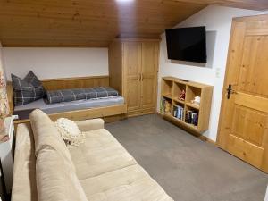 a living room with a couch and a flat screen tv at Comfort-Appartement Keiler in Schlitters