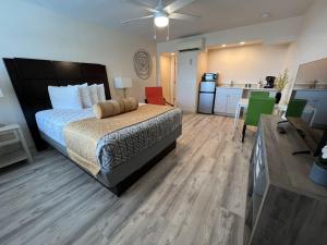 a large bedroom with a bed and a kitchen at Beachside Resort Motel in St Pete Beach