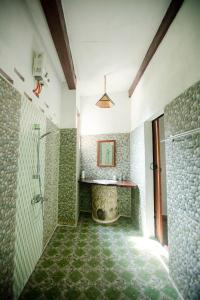 a bathroom with a shower and a sink and a shower at Green Travelodge Bukit Lawang in Bukit Lawang