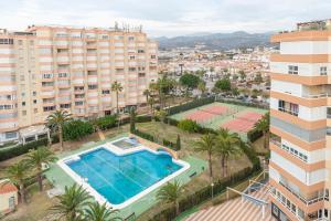 an apartment with a pool and two tennis courts at Seafront Luxury Penthouse Torrox Costa in Torrox