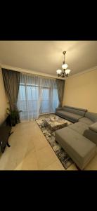 a living room with a couch and a ceiling fan at Dream Beach View in Ajman 