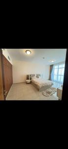a bedroom with two beds and a large window at Dream Beach View in Ajman 