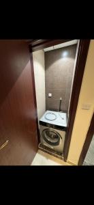 a small bathroom with a toilet in a room at Dream Beach View in Ajman 