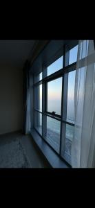 a room with a window with a view of the ocean at Dream Beach View in Ajman 
