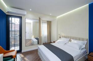 a bedroom with a large bed and a window at Latorre Hotel in Yerevan