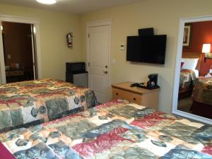 מיטה או מיטות בחדר ב-Sahara Suites