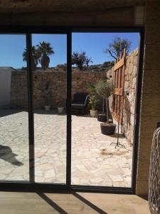 a view of a patio through a sliding glass door at Höhlenapartment in Güimar
