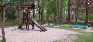 a playground with a slide in a park at Apartman U Parku in Dvůr Králové nad Labem