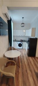 a kitchen with a table and two chairs and a table at Guest House Alazani Valley in Sighnaghi