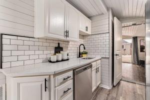 una cocina con armarios blancos y fregadero en Beautiful Southhaven Shores, en South Haven