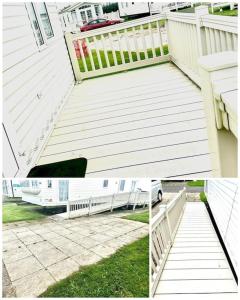 a white house with a porch and a white fence at Withernsea Sands - Disabled friendly (maple grove) in Withernsea