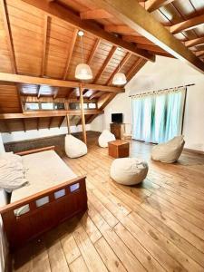 a large room with two beds and a wooden floor at La Rosada Casa de Campo in General Las Heras