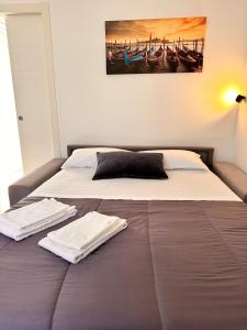 a bedroom with a bed with two towels on it at Bnb apartment Ferrara in Udine