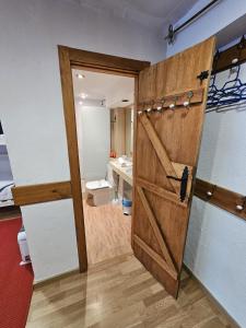 a door in a room with a bathroom at IMEDA CASA LOS PINOS in Sierra Nevada
