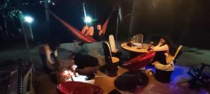 a group of people sitting around a table in a room at HOME HOSTEL ELLA private rooms only in Ella